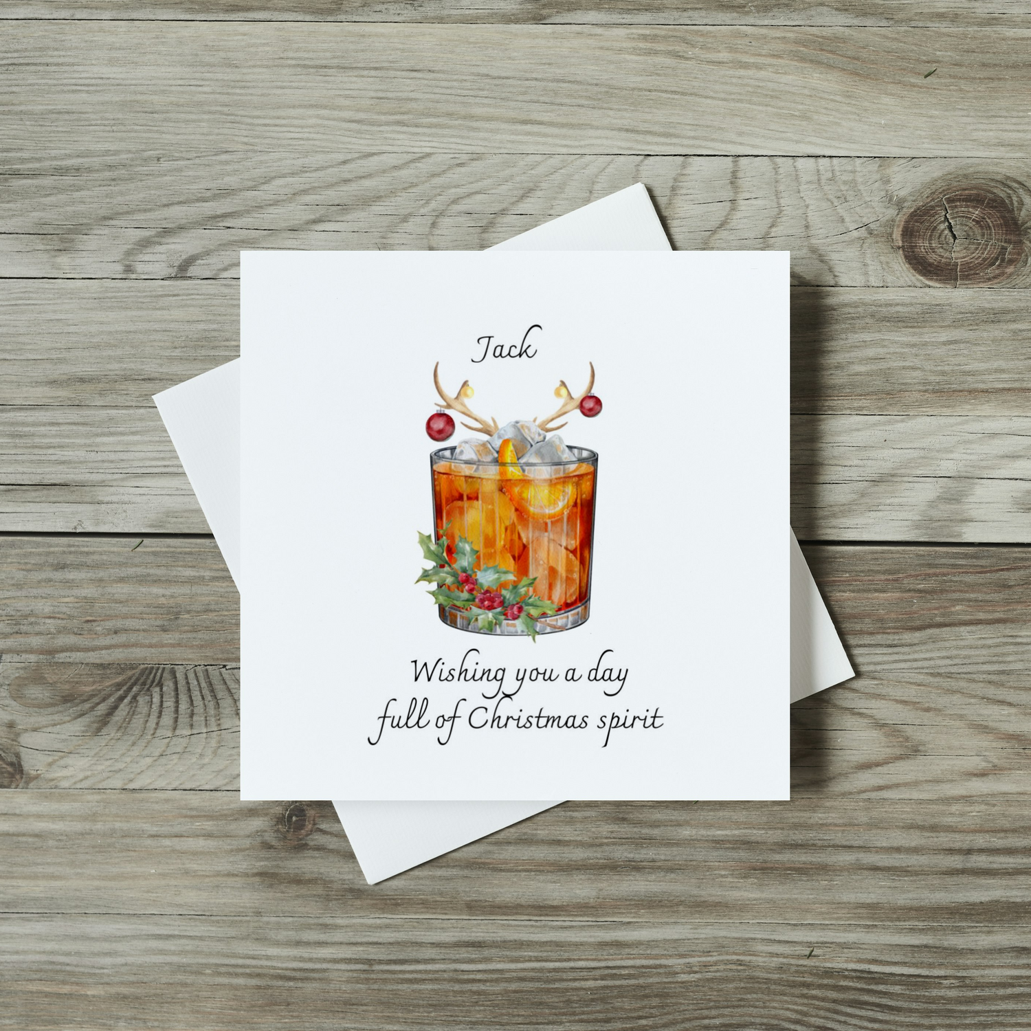 front of christmas card with watercolour glass of whiskey and reindeer antlers
