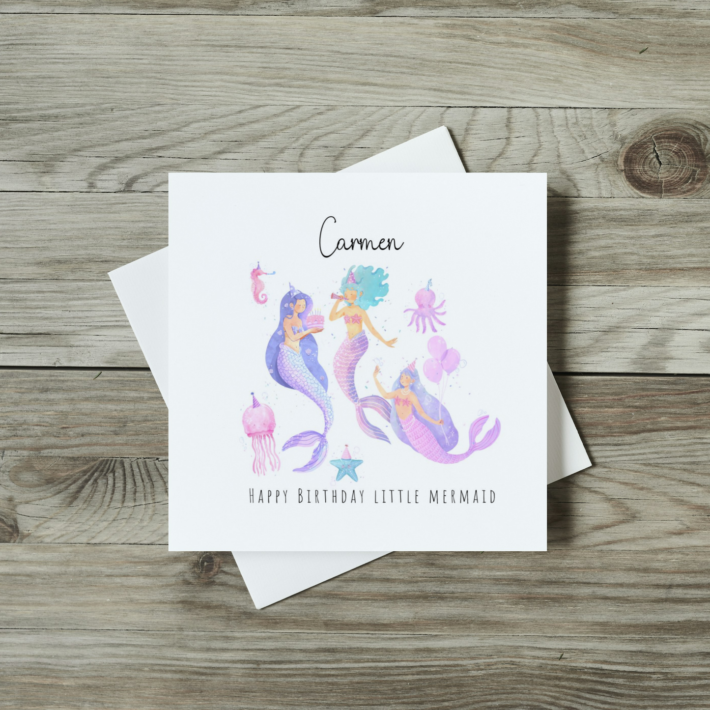 front of childrens mermaid birthday card featuring watercolour mermaids and sea creatures having a party