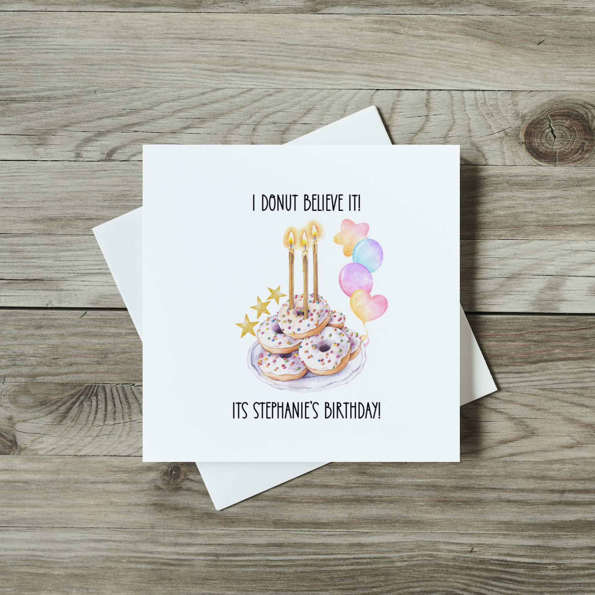 front of donut birthday card featuring watercolour donuts with candles in, balloons and stars