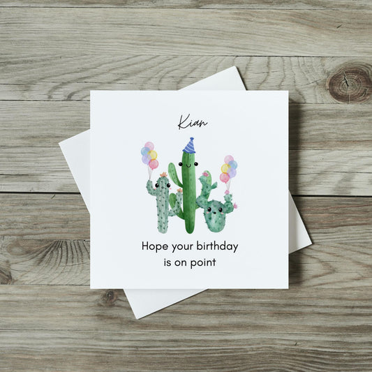 front of cute cactus card, smiling cacti holding birthday balloons, hope your birthday is on point for children