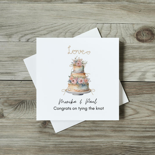 Front of wedding day card, watercolour wedding cake with heart knots 