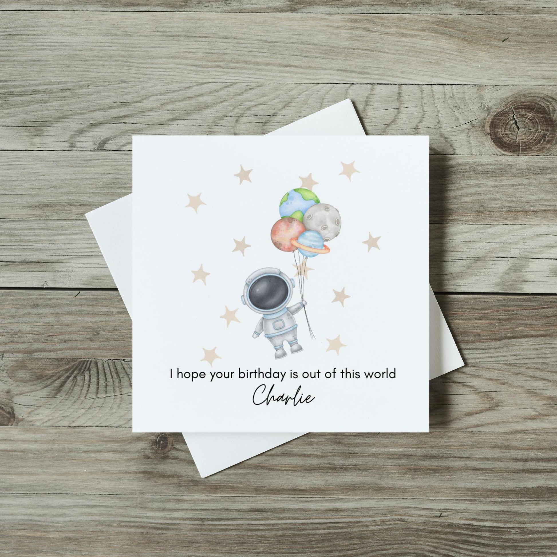 front of childrens astronaut card with cute watercolour astronaut holding plant balloons with sparkly stars