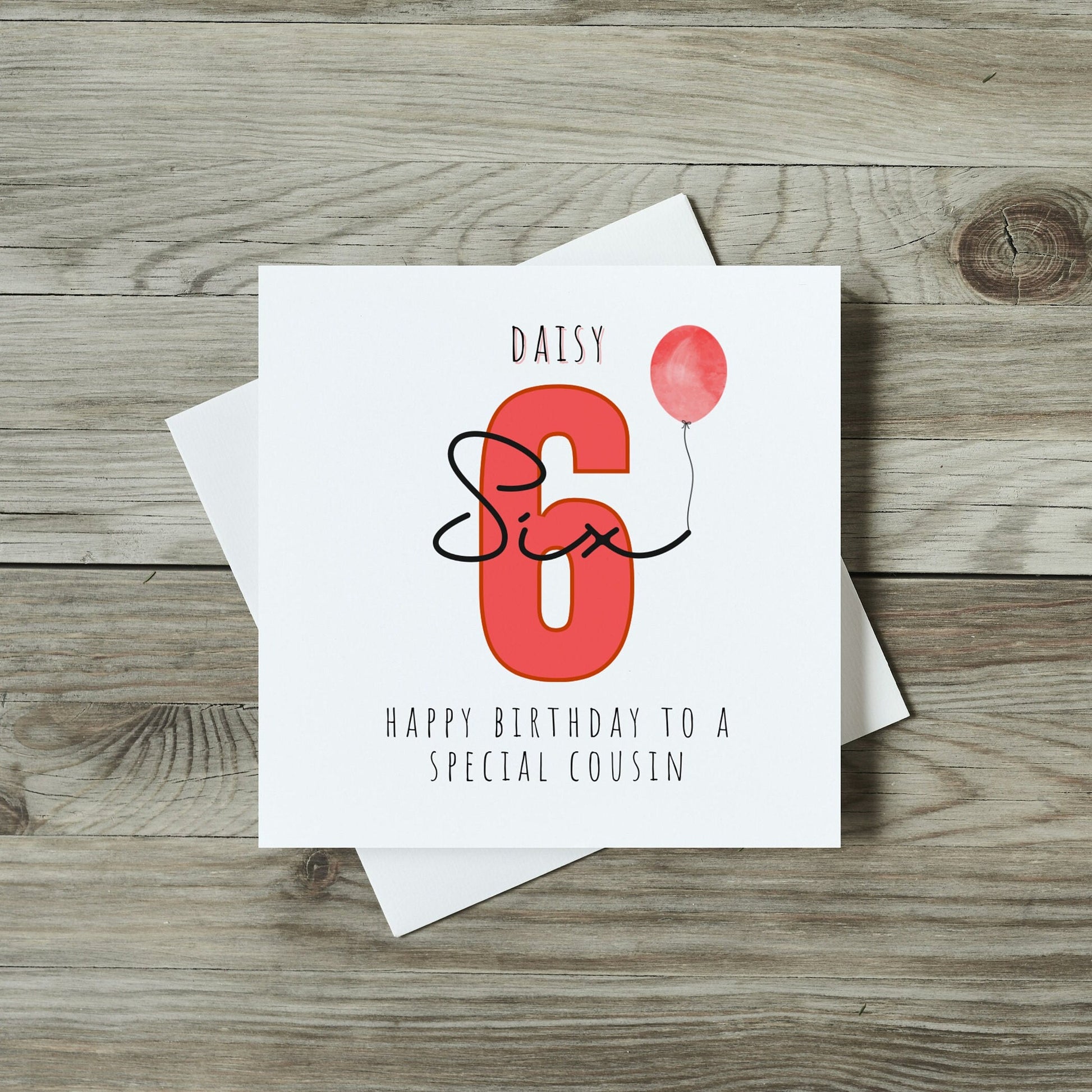 front of childrens birthday card with large number six in red and personalised name