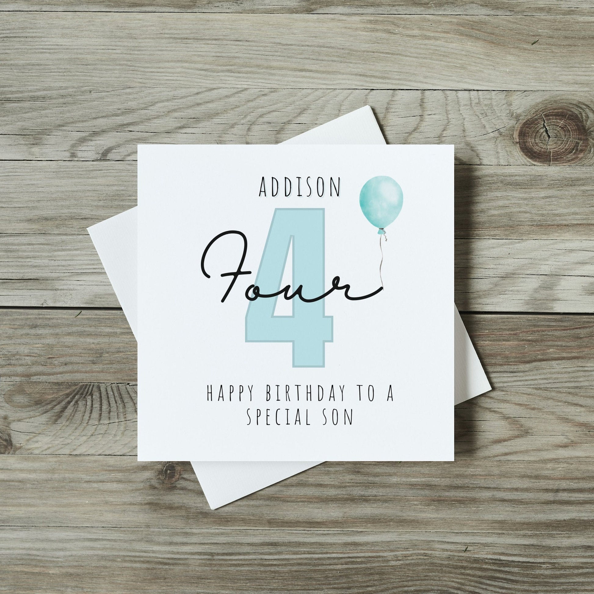 front of childrens birthday card with large number four for 4th birthday in blue and personalised name