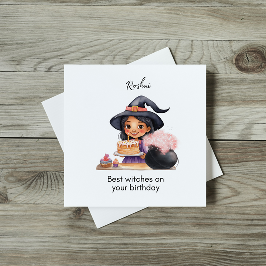 front of watercolour childrens halloween witch birthday card featuring brown girl wearing withes hat and holding birthday cake